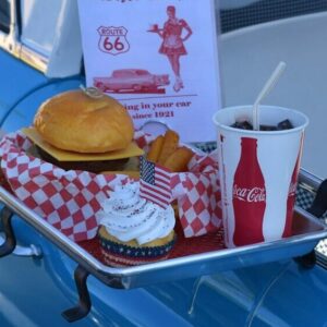 The standard american diet, hamburger, soda, and ice cream set next to pick-up