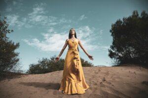 Women;s Health, woman in yellow dress standing on brown sand under blue sky during daytime